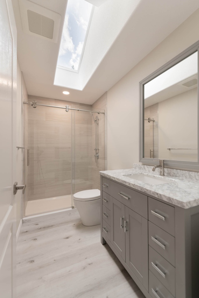Small bathroom with a walk-in shower. Light colours into the design