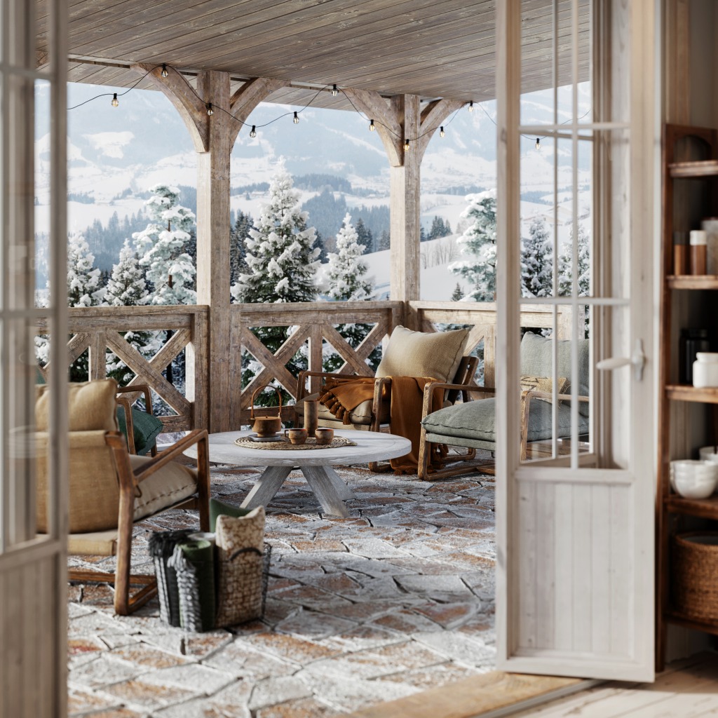 Beautiful snowy winter cottage balcony with wooden center table, armchairs and coffee cups.
